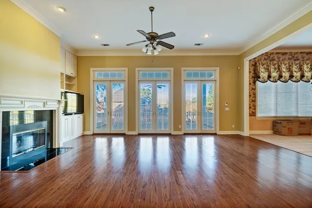 a view of an entryway with wooden floor fireplace and a window