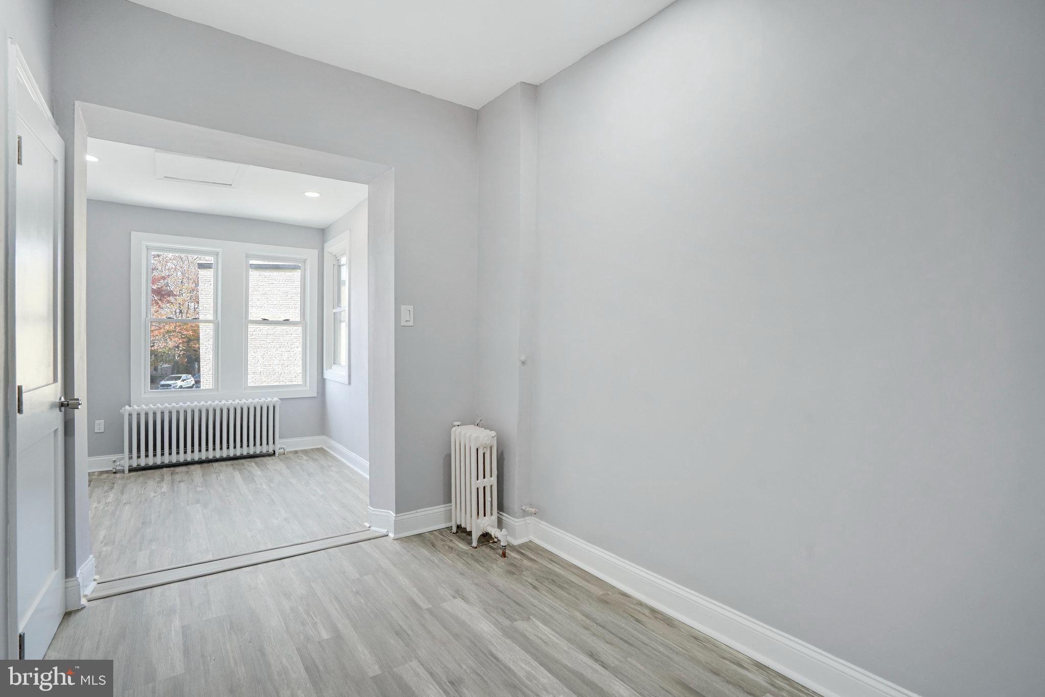 1273 Holbrook Terrace Northeast Washington, DC 20002 - Photo 12 of 24 a view of empty room with wooden floor and fan