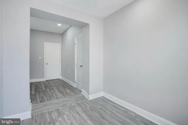 a view of an empty room and wooden floor