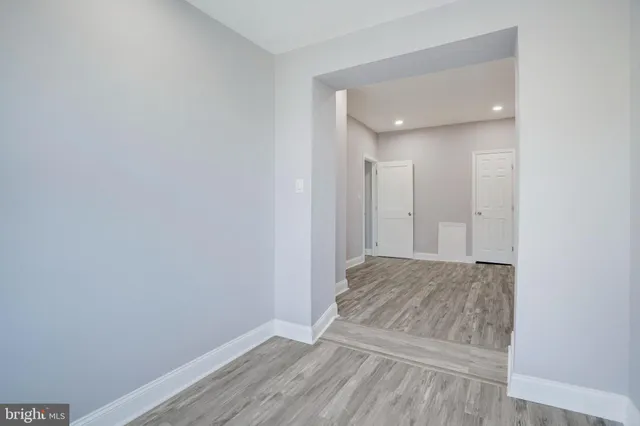 a view of an empty room and wooden floor