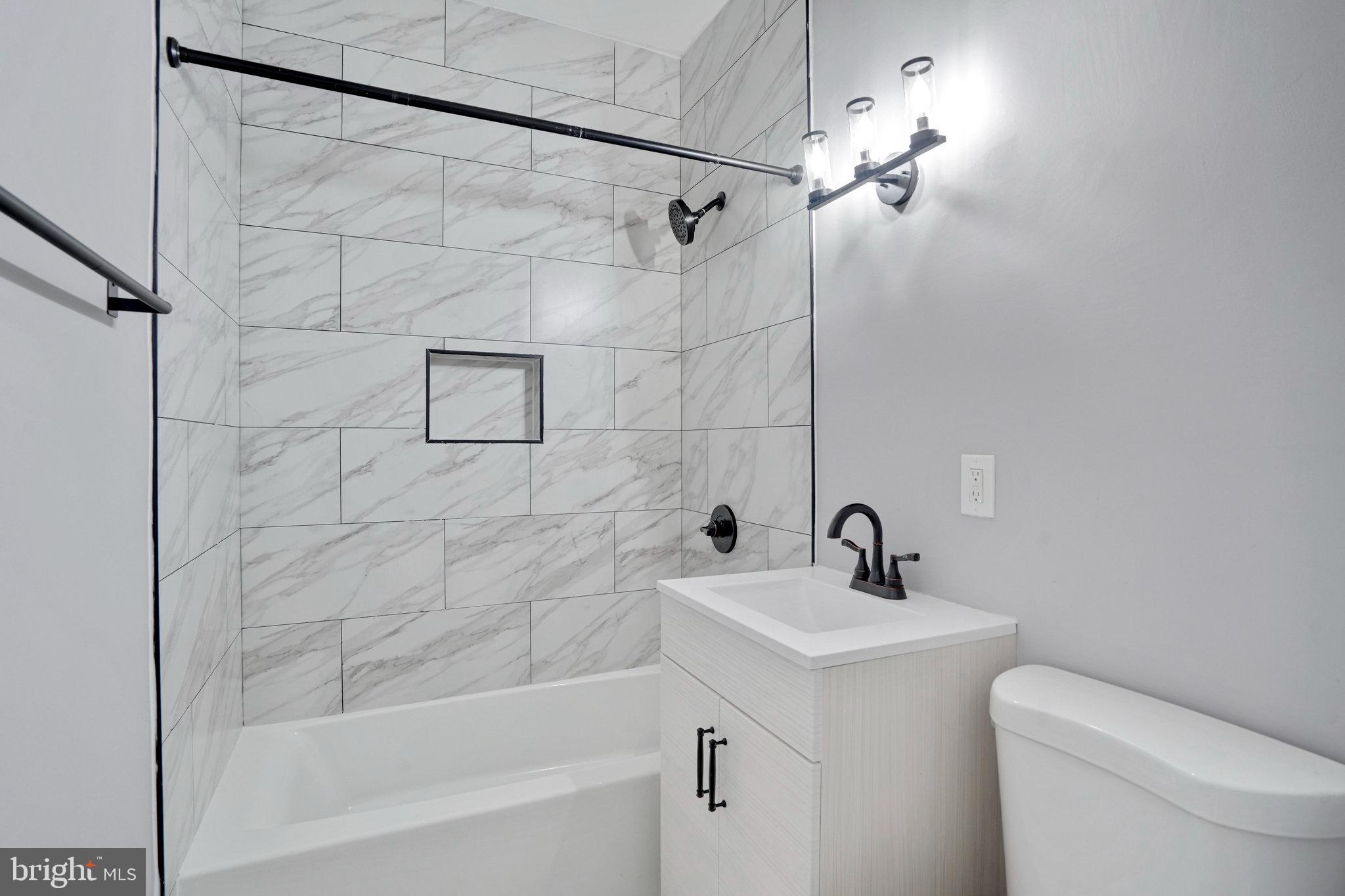 1273 Holbrook Terrace Northeast Washington, DC 20002 - Photo 16 of 24 a bathroom with a sink a toilet and shower
