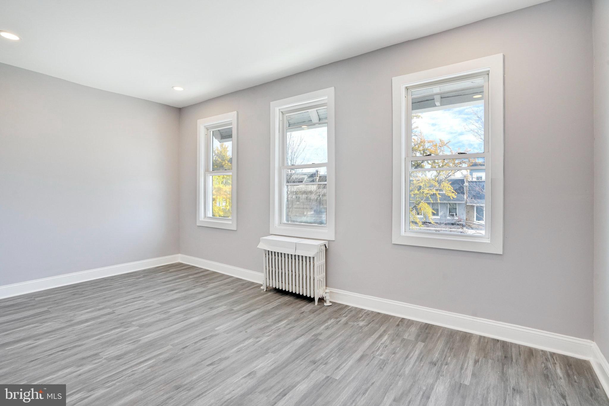 1273 Holbrook Terrace Northeast Washington, DC 20002 - Photo 18 of 24 a view of an empty room with wooden floor and a window