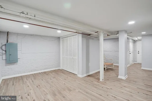 a view of empty room with wooden floor and window