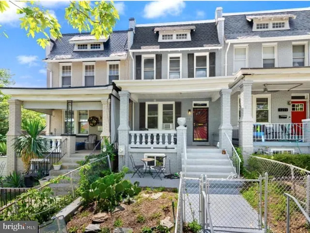 a front view of a house with outdoor seating