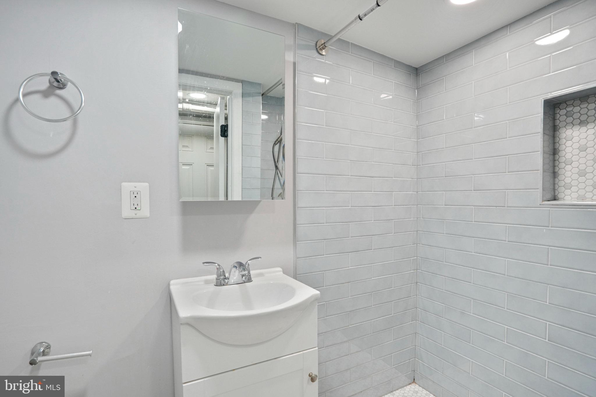 1273 Holbrook Terrace Northeast Washington, DC 20002 - Photo 22 of 24 a bathroom with a sink a toilet and shower