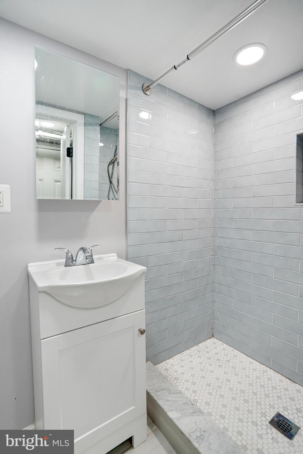 1273 Holbrook Terrace Northeast Washington, DC 20002 - Photo 23 of 24 a bathroom with a sink a toilet and a mirror