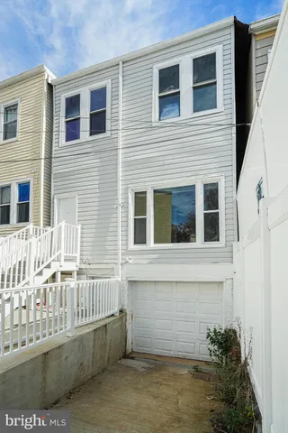 a view of a house with a small deck
