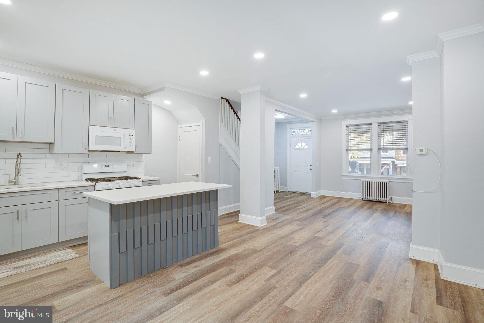 1273 Holbrook Terrace Northeast Washington, DC 20002 - Photo 7 of 24 a kitchen with wooden floors and cabinets