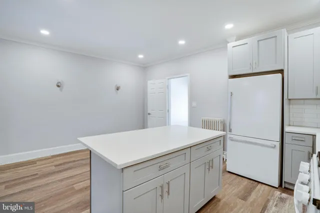 a kitchen with a refrigerator and a sink