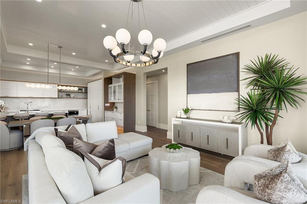 201 8th Street South, Unit 301 Naples, FL 34102 - Photo 13 of 43 a living room with furniture a chandelier and kitchen view