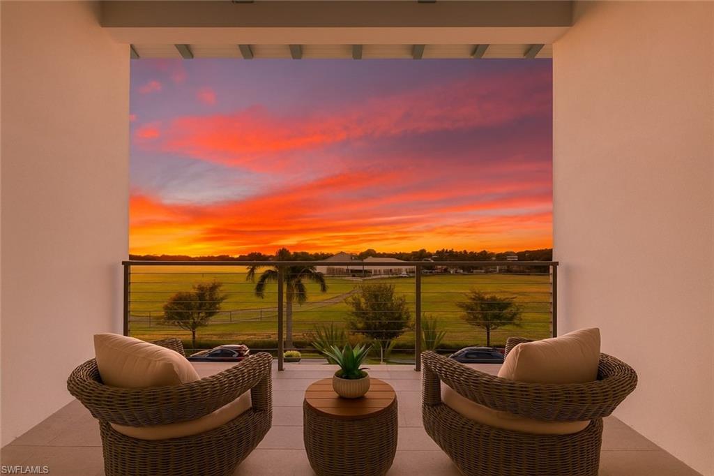 201 8th Street South, Unit 301 Naples, FL 34102 - Photo 16 of 43 a balcony with seating area and swimming pool