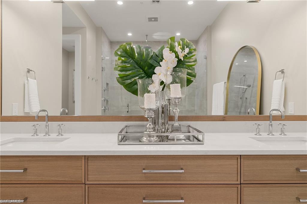 201 8th Street South, Unit 301 Naples, FL 34102 - Photo 18 of 43 a bathroom with a sink a vanity and a mirror