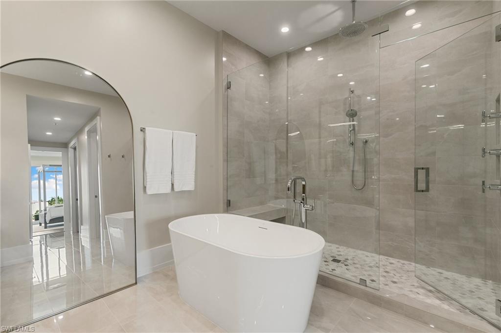 201 8th Street South, Unit 301 Naples, FL 34102 - Photo 19 of 43 a bathroom with a bathtub and a shower