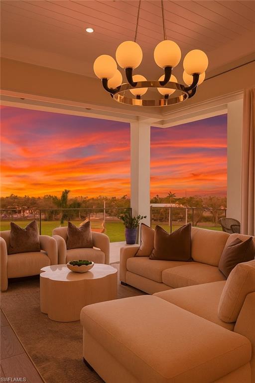 201 8th Street South, Unit 301 Naples, FL 34102 - Photo 2 of 43 a living room with furniture a chandelier and a floor to ceiling window