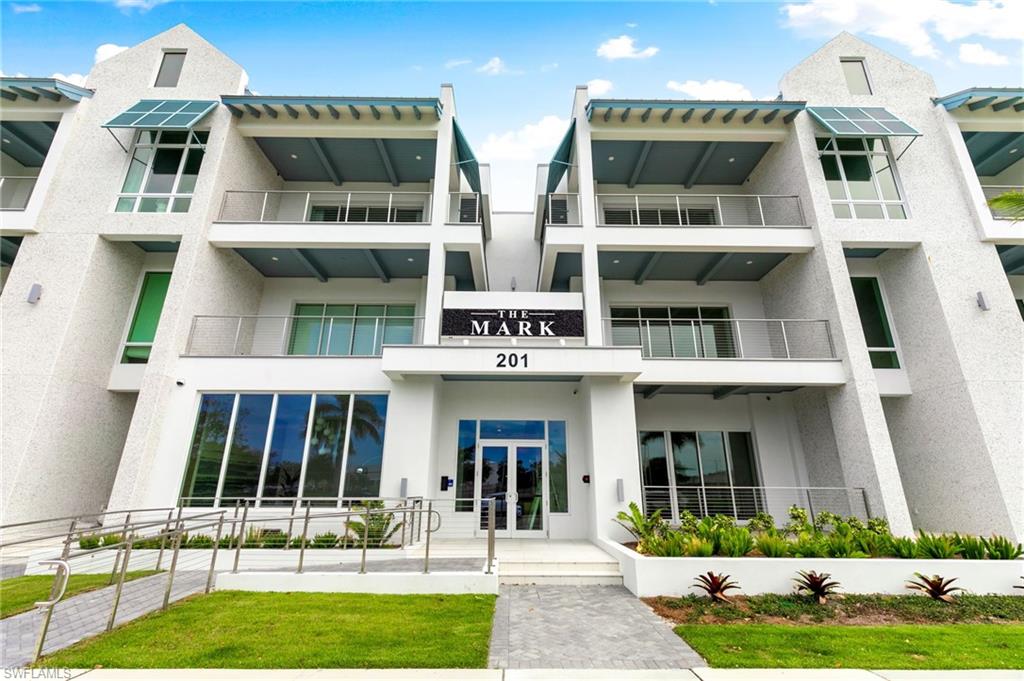 201 8th Street South, Unit 301 Naples, FL 34102 - Photo 31 of 43 a view of a building with a yard