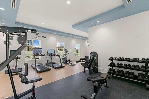 a room with gym equipment and a flat screen tv