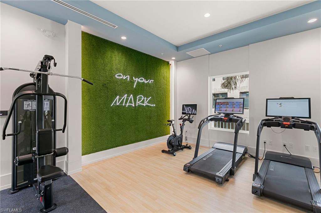 201 8th Street South, Unit 301 Naples, FL 34102 - Photo 37 of 43 a room with gym equipment and a flat screen tv