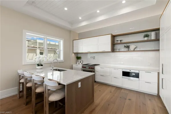 a kitchen with a stove a sink and a refrigerator