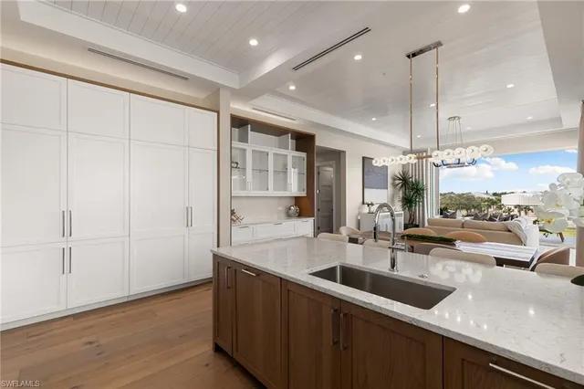a kitchen with sink attached with living room