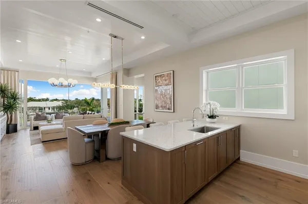 a kitchen with kitchen island granite countertop a sink cabinets and window