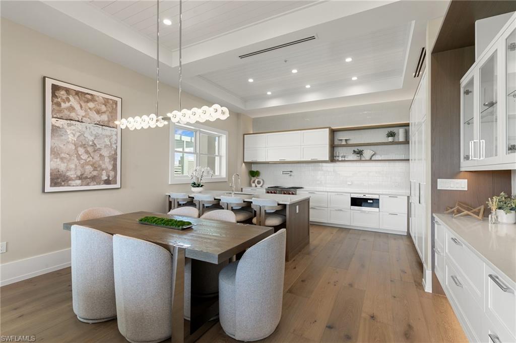 201 8th Street South, Unit 301 Naples, FL 34102 - Photo 8 of 43 a kitchen with kitchen island granite countertop a sink cabinets and window