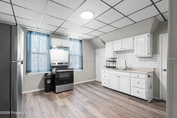 a kitchen with stainless steel appliances a stove sink and refrigerator