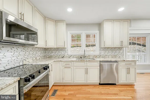 a open kitchen with granite countertop a stove top oven sink and cabinets