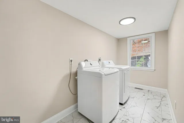 a bathroom with a sink a toilet and a window
