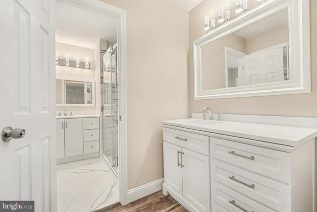 a bathroom with a shower and a sink