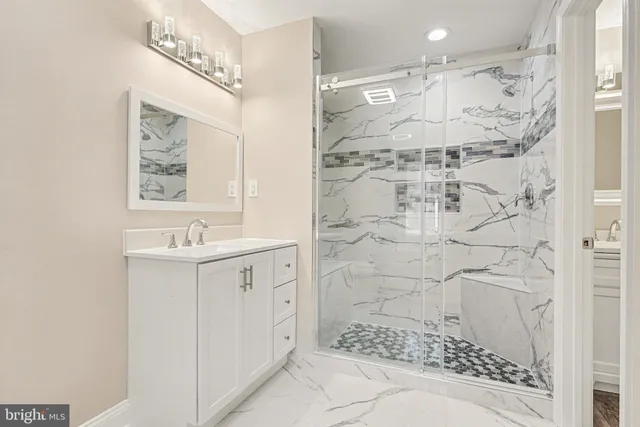 a bathroom with a sink toilet and a mirror