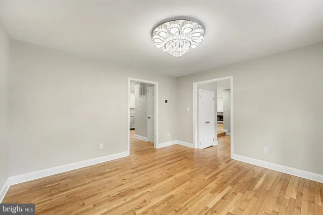 a view of a room with wooden floor and a window