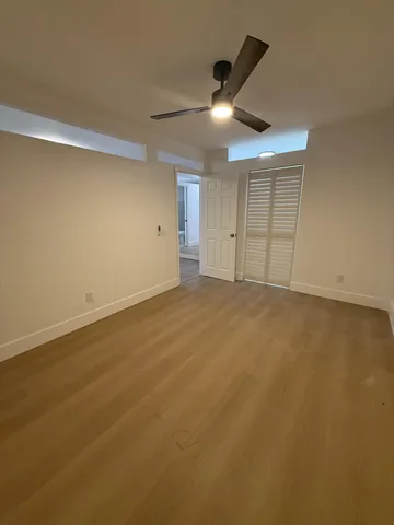 a bathroom with a toilet sink a mirror and shower