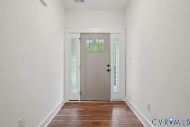 a view of empty room with fireplace and windows