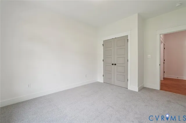 an empty room with closet area