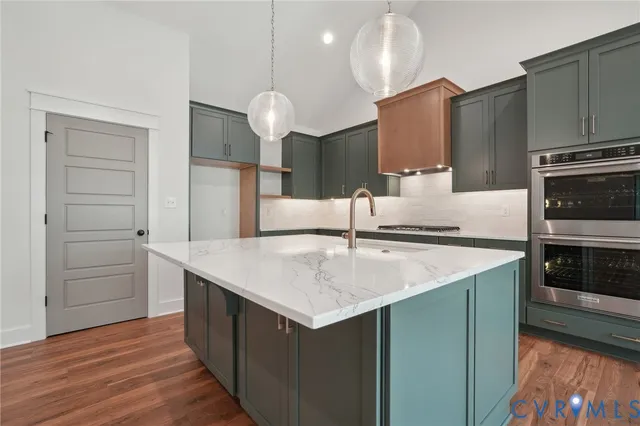 a kitchen with a sink cabinets and wooden floor