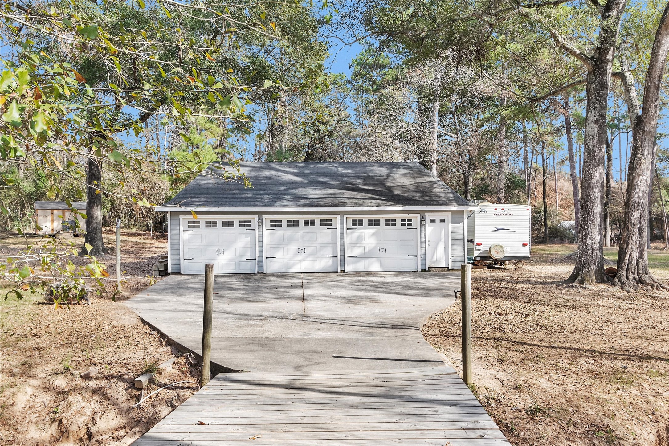 40610 Mill Creek Road Magnolia, TX 77354 - Photo 26 of 31 3 car garage Seller has added more reinforcement to the bridge. Garage has been partially finshed out. Their is a gate leading over to the back pastures.