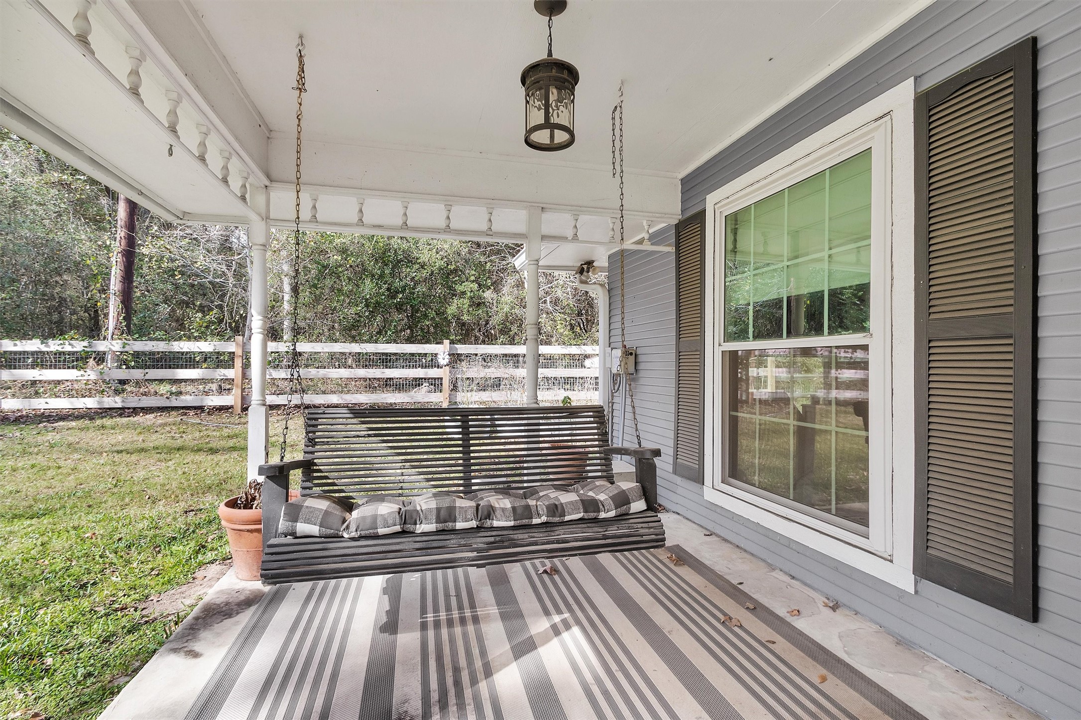 40610 Mill Creek Road Magnolia, TX 77354 - Photo 5 of 31 Ready to relax sellers are leaving this porch swing for the buyers. Enjoy this full covered front porch