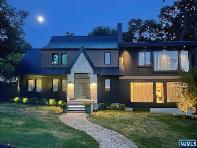 a front view of house with a garden