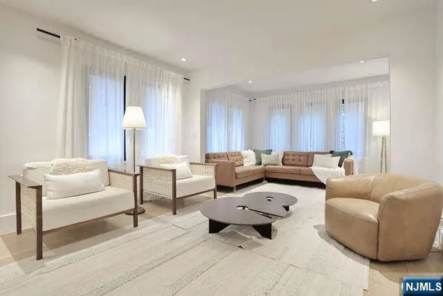 a white bath tub sitting next to a shower