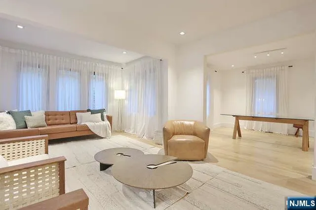 a large bedroom with a large bed and a large window