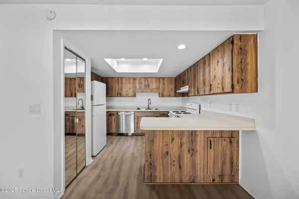 a kitchen with a refrigerator a sink and cabinets