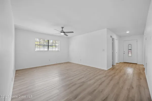 wooden floor in an empty room with a window