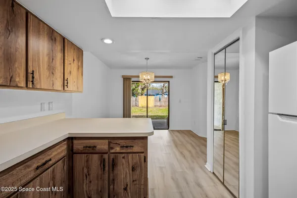a kitchen with a refrigerator and a sink
