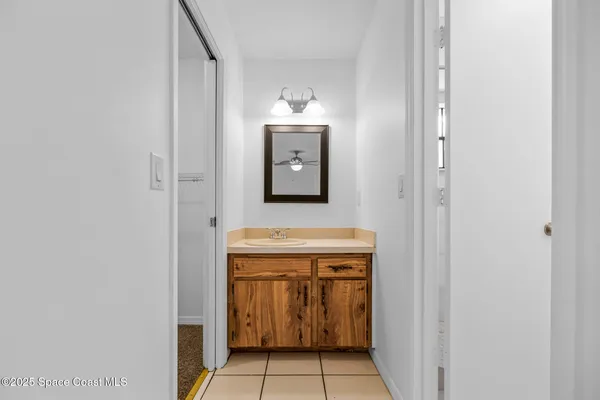 a hallway with a sink and a mirror