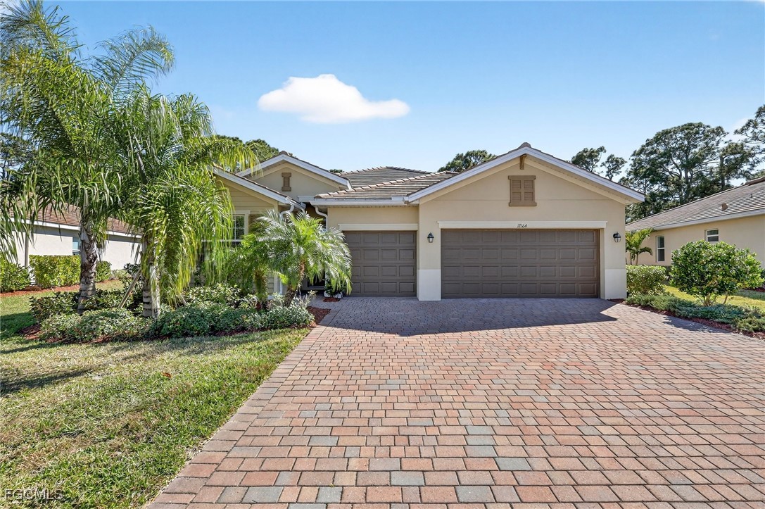17364 Walnut Run Drive Alva, FL 33920 - Photo 1 of 50 a front view of a house with a yard and garage
