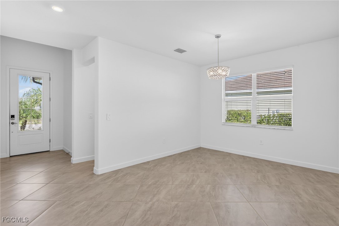17364 Walnut Run Drive Alva, FL 33920 - Photo 13 of 50 an empty room with windows and plants