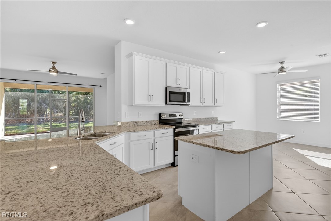 17364 Walnut Run Drive Alva, FL 33920 - Photo 16 of 50 a kitchen with sink stove and cabinets