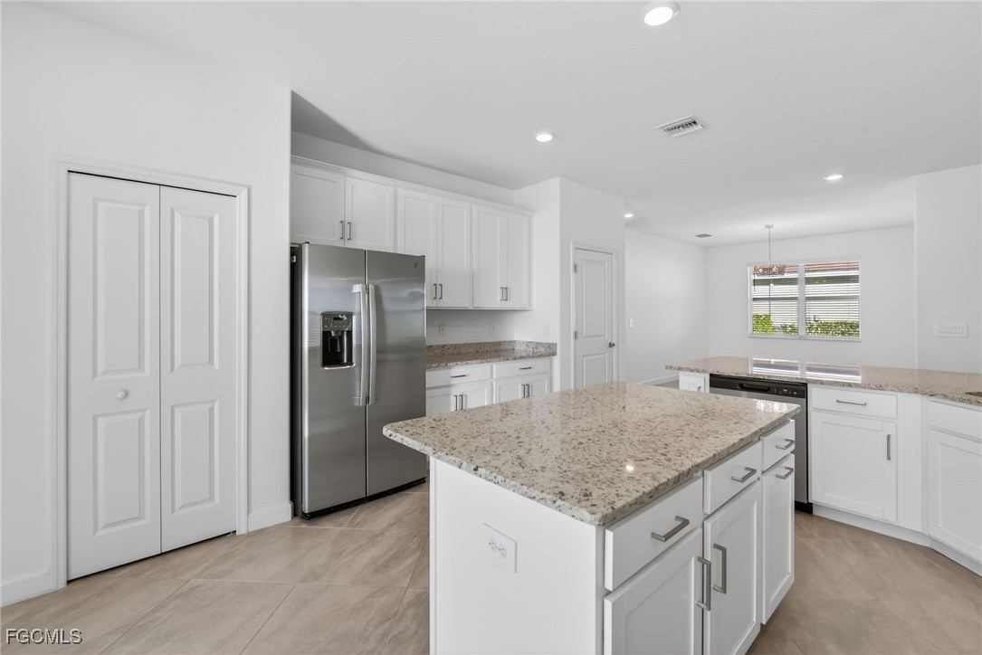17364 Walnut Run Drive Alva, FL 33920 - Photo 19 of 50 a kitchen with a stove a refrigerator and a sink