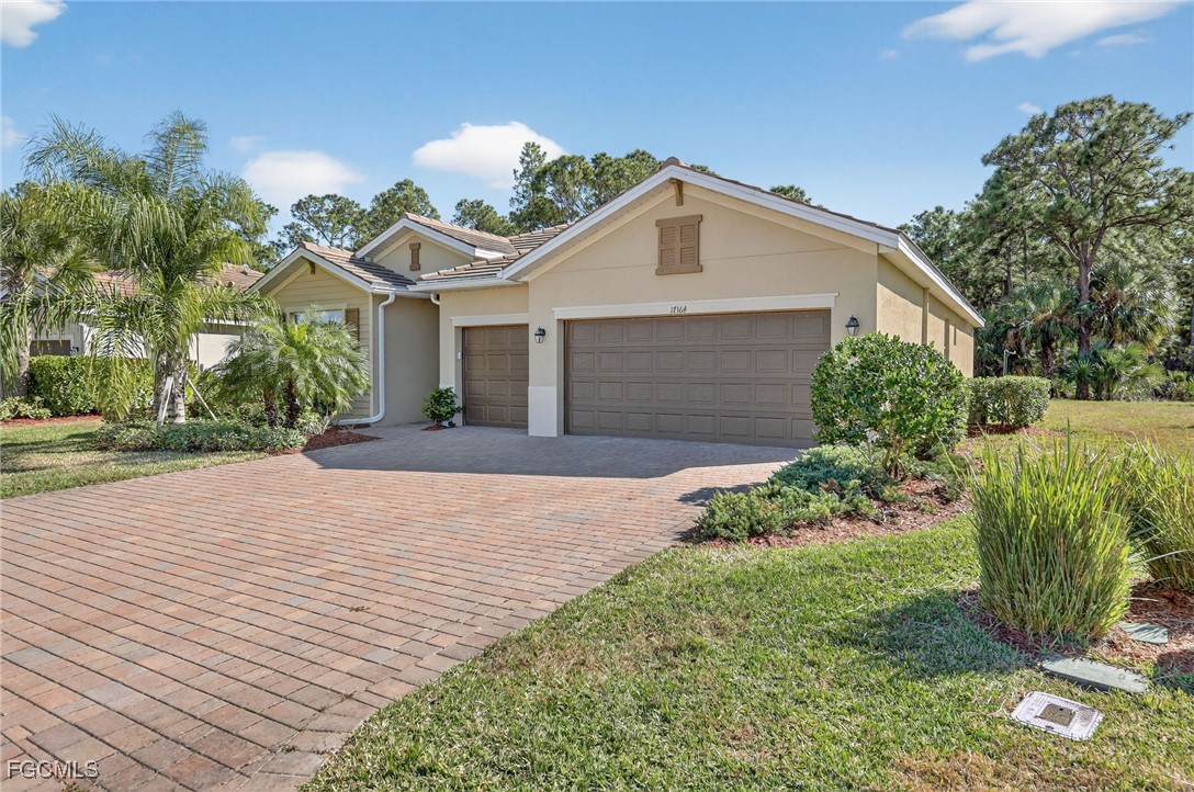 17364 Walnut Run Drive Alva, FL 33920 - Photo 2 of 50 a front view of a house with garden