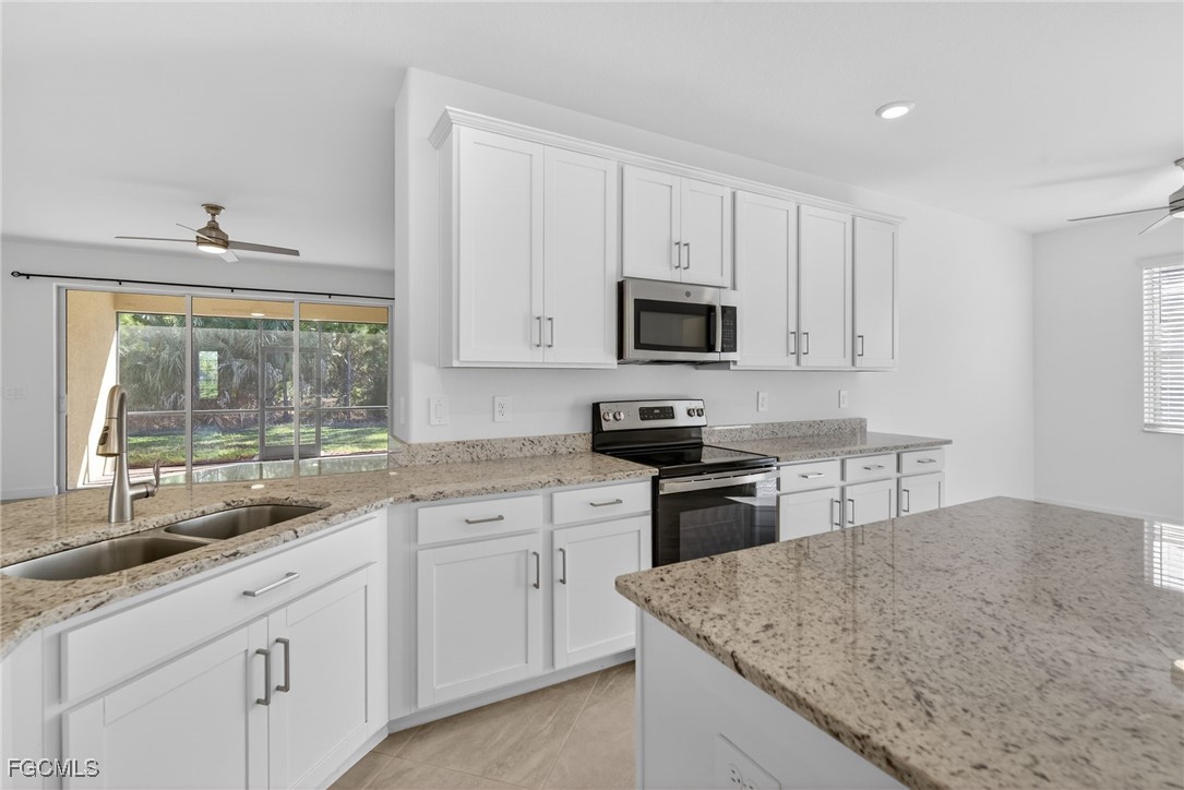 17364 Walnut Run Drive Alva, FL 33920 - Photo 23 of 50 a kitchen with sink cabinets and appliances